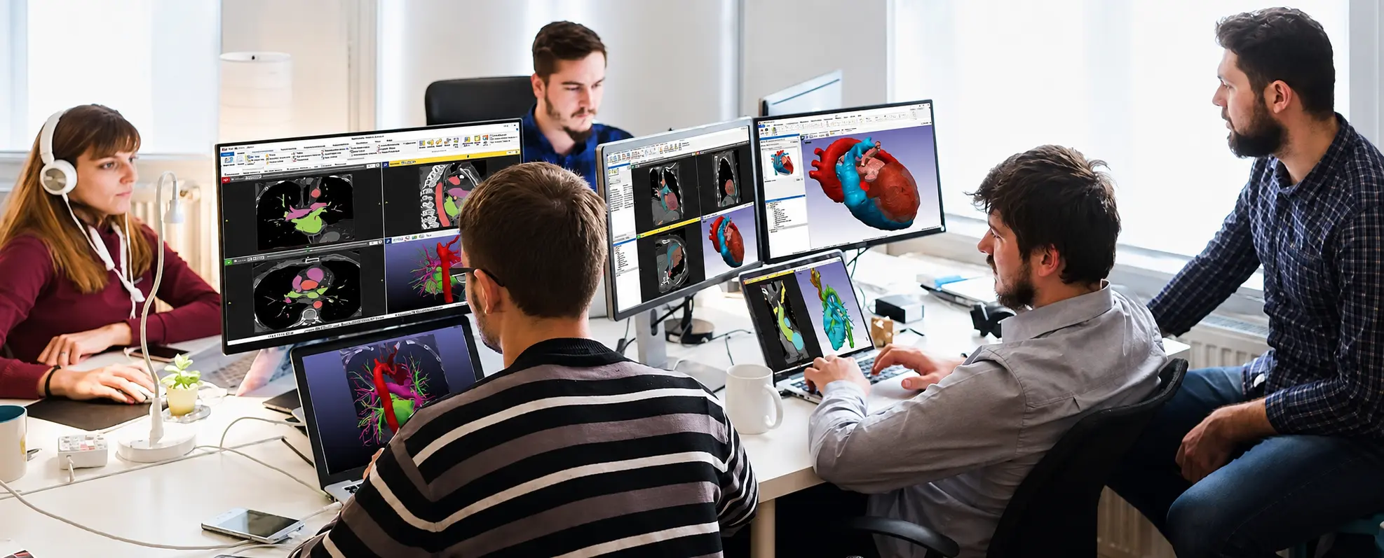 Équipe d'ingénieurs en biomédical collaborant sur la conception 3D de dispositifs médico-chirurgicaux à partir d'images scanner et de modèles anatomiques.